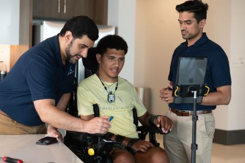 Kinemo co-founders Nordine Sebkhi and Arpan Bhavsar work with Wendell Odom during an assistive technology session using the Kinemo device to support independent computer and device control.