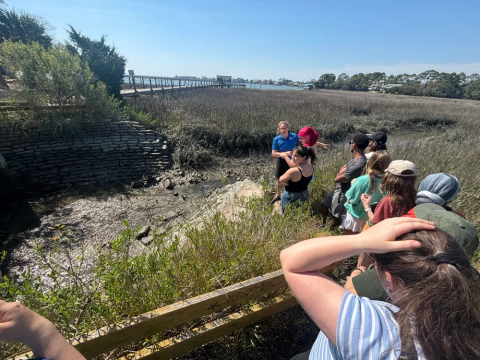 Jill Gambill, executive director and senior research associate of the CEAR Hub, demonstrates a tide gate engineered to maintain storm sewer outflow capacity amidst rising sea levels to Georgia Tech students.