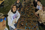 The RotorJackets pose in front of their drones at the Collegiate Drone Racing Championship. 